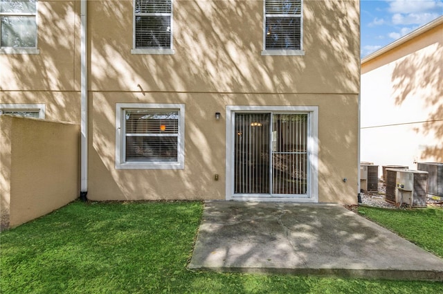 back of house with a patio, central AC, and a lawn