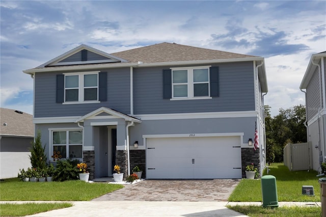 view of front of home featuring a front yard and a garage