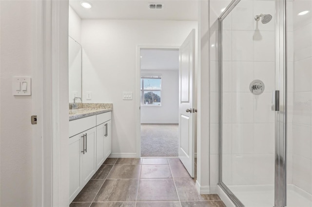 bathroom with vanity and an enclosed shower