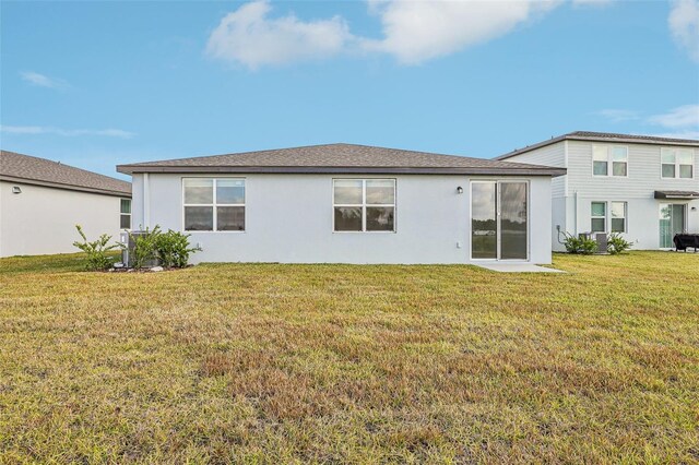 rear view of property with a lawn