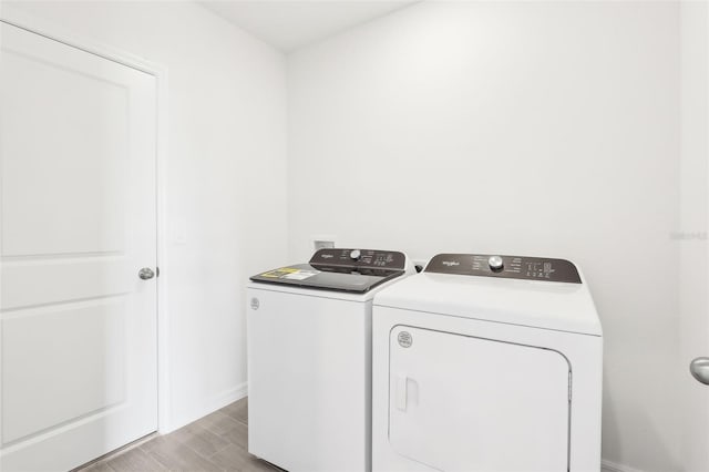 clothes washing area with separate washer and dryer