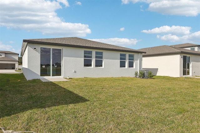 rear view of property with a lawn