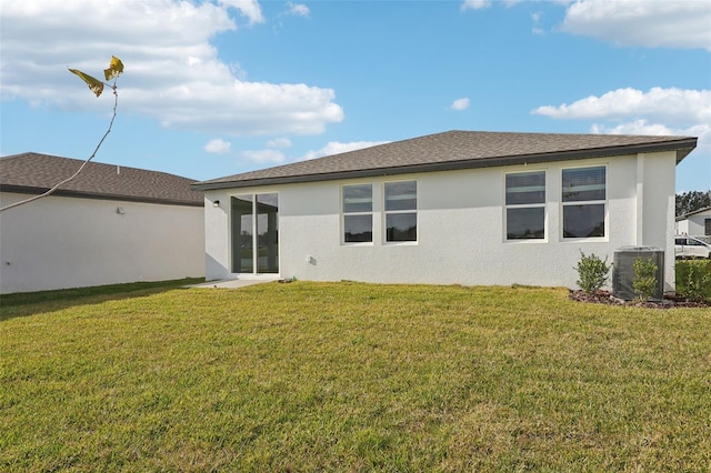 back of property featuring a yard and central AC unit