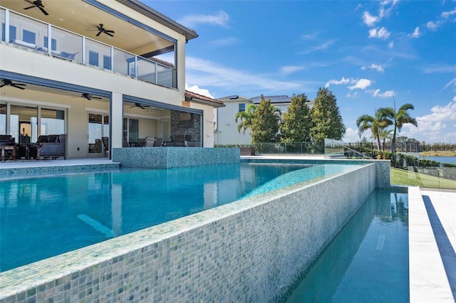 view of pool featuring a patio, ceiling fan, and an outdoor hangout area