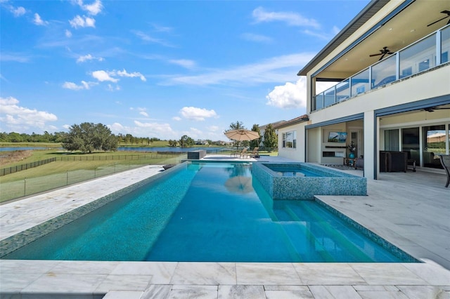 view of pool with a patio, an in ground hot tub, and ceiling fan