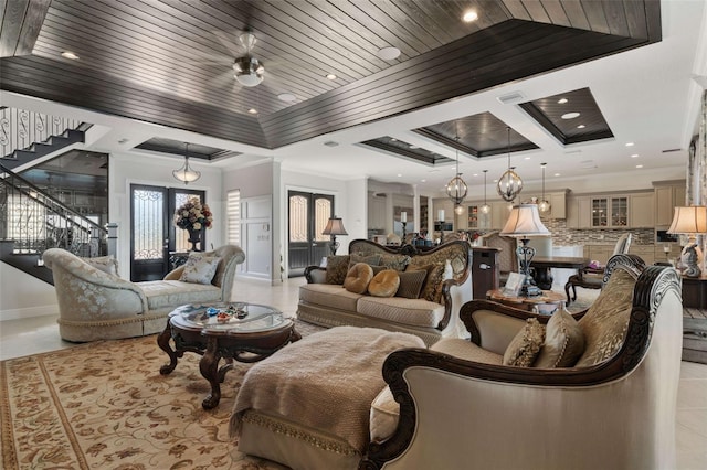 tiled living room with french doors, wood ceiling, ornamental molding, and ceiling fan