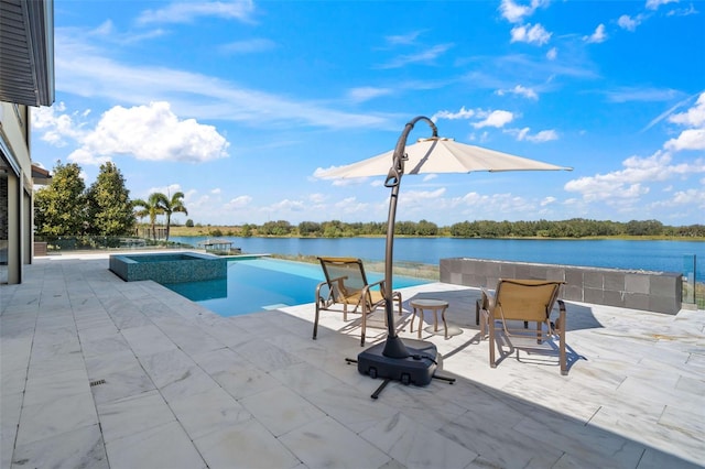 view of pool featuring a patio, an in ground hot tub, and a water view