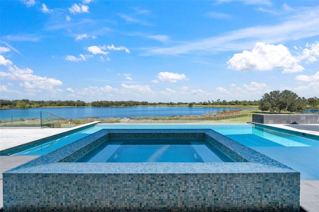 view of swimming pool featuring an in ground hot tub and a water view