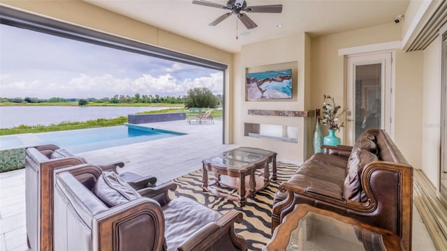 view of patio / terrace with an outdoor hangout area, a water view, and ceiling fan