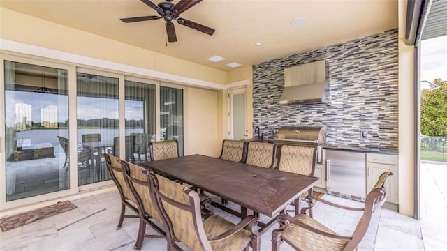 view of patio featuring an outdoor kitchen and ceiling fan