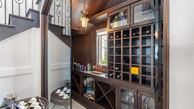 wine area featuring lofted ceiling and tile patterned floors