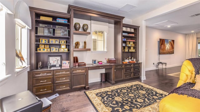 office area featuring built in desk and dark hardwood / wood-style floors