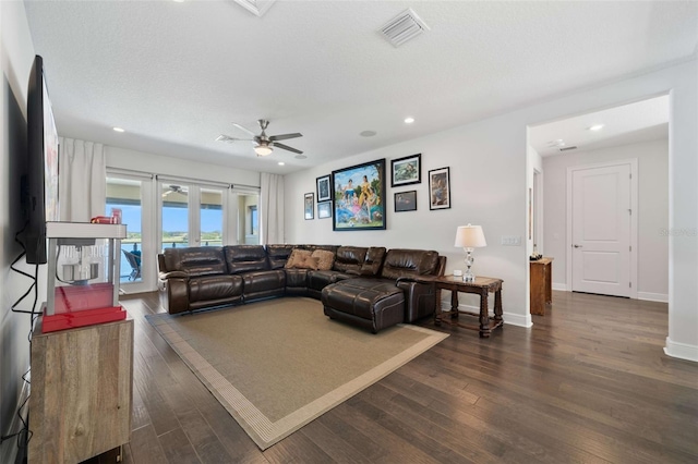 living room with french doors, dark hardwood / wood-style floors, and ceiling fan