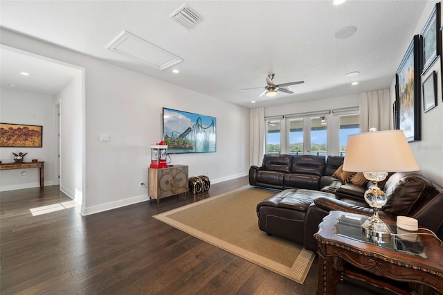 living room with dark hardwood / wood-style floors, a textured ceiling, and ceiling fan