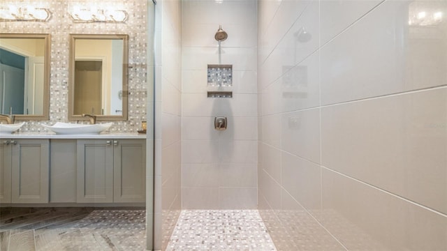 bathroom with vanity and tiled shower