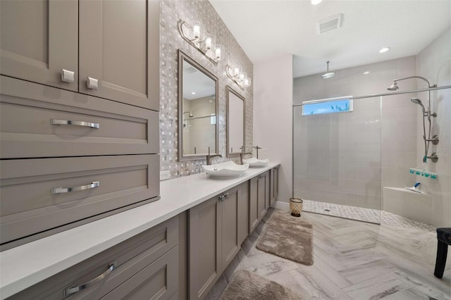 bathroom with vanity and tiled shower