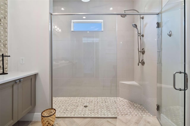 bathroom featuring vanity and an enclosed shower