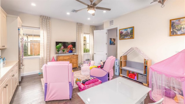 recreation room featuring ceiling fan and hardwood / wood-style floors