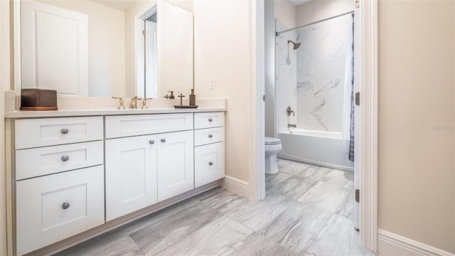 full bathroom with vanity, toilet, and tiled shower / bath combo