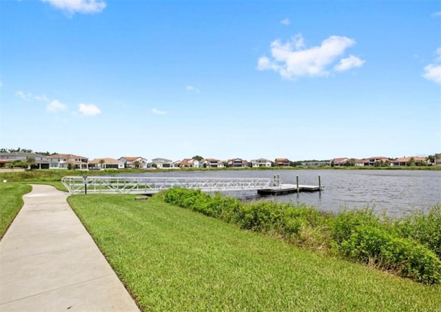 dock area with a water view and a yard