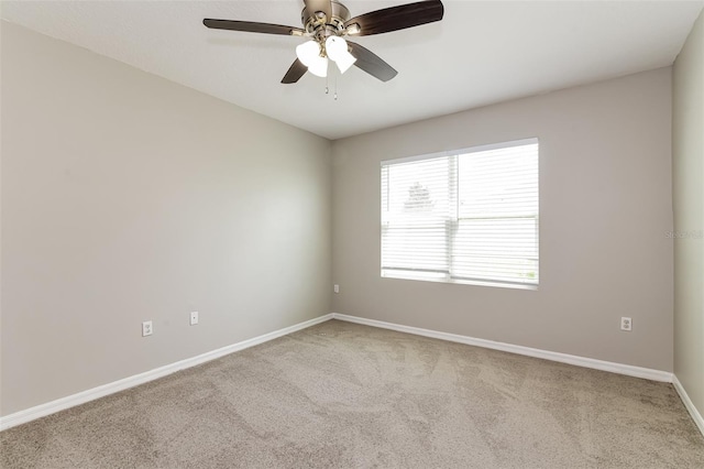 unfurnished room featuring light colored carpet and ceiling fan