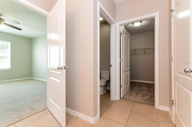 2036 Van Buren Loop, Auburndale, FL 33823 - hallway with light carpet, light tile patterned flooring, and baseboards