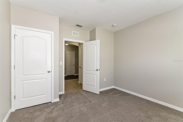 2036 Van Buren Loop, Auburndale, FL 33823 - unfurnished bedroom featuring carpet floors, baseboards, and a textured ceiling