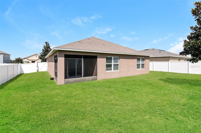 back of house featuring a yard