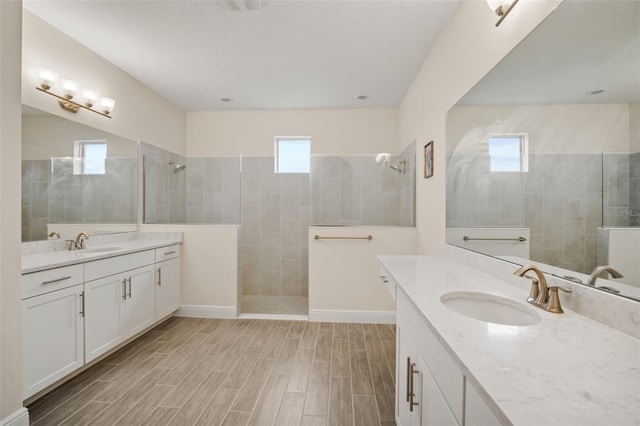 bathroom featuring vanity and tiled shower