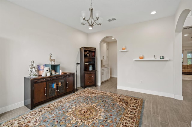 interior space featuring an inviting chandelier and hardwood / wood-style floors