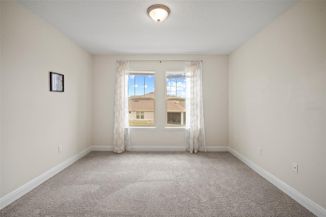 spare room with light colored carpet