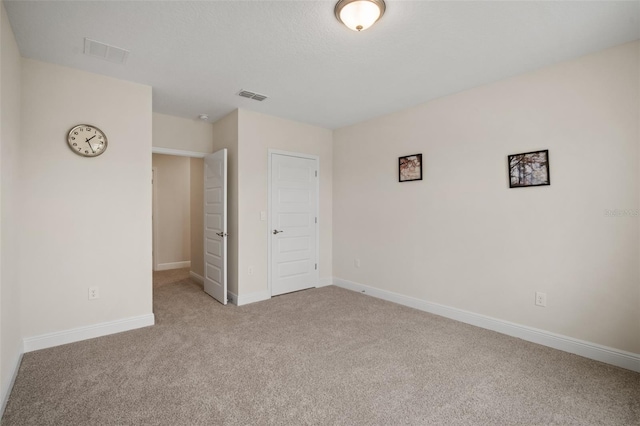 unfurnished bedroom with light colored carpet