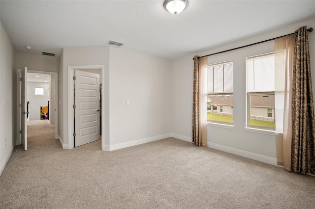 unfurnished bedroom with light colored carpet