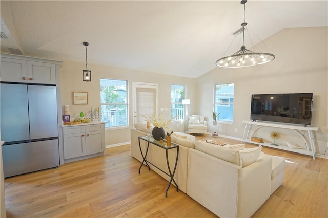 living room with lofted ceiling and light hardwood / wood-style flooring