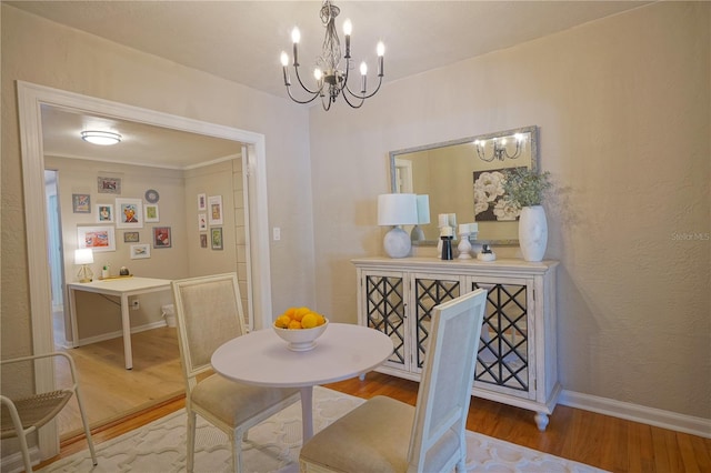 dining area with an inviting chandelier and hardwood / wood-style floors