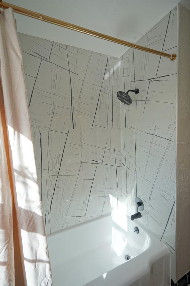 bathroom with shower / bath combo with shower curtain