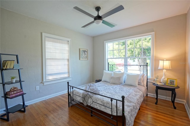 bedroom with hardwood / wood-style floors and ceiling fan