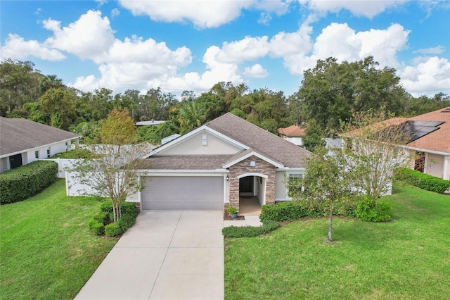 ranch-style home featuring a front lawn and a garage