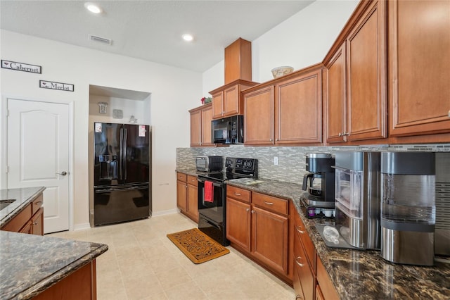 kitchen with light tile patterned flooring, dark stone countertops, tasteful backsplash, and black appliances