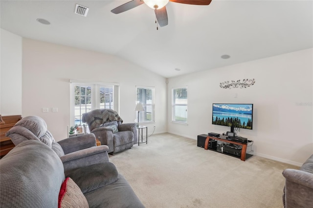 living room with ceiling fan, lofted ceiling, plenty of natural light, and light colored carpet