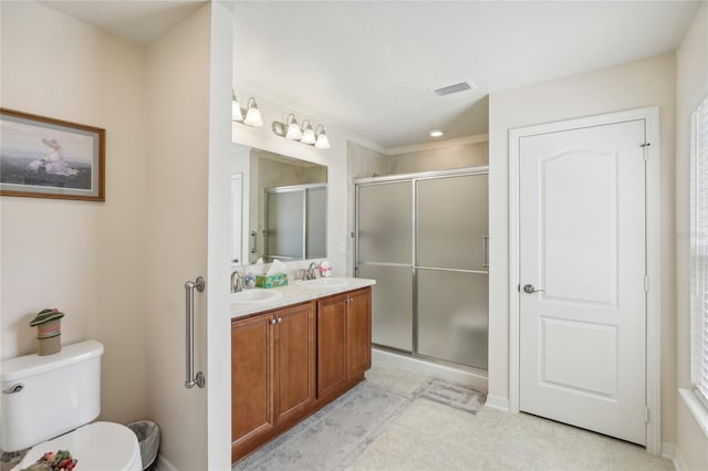 bathroom featuring a shower with door, toilet, and vanity