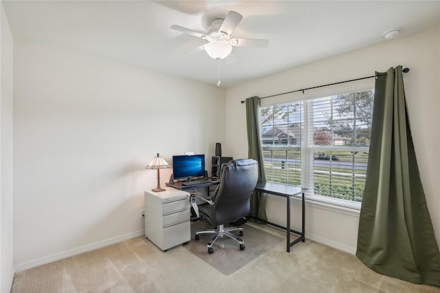 home office featuring light carpet and ceiling fan