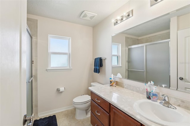 bathroom featuring vanity, tile patterned flooring, toilet, and an enclosed shower