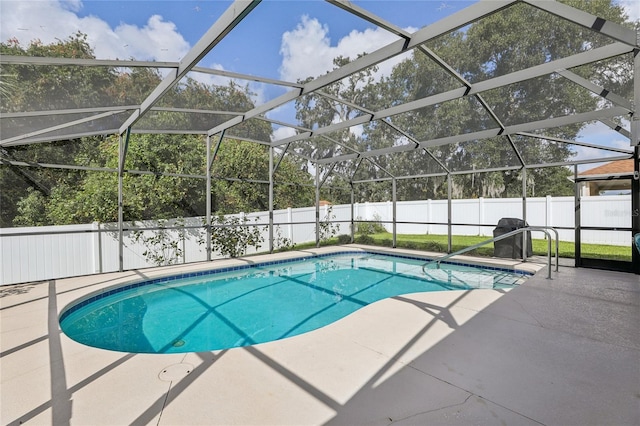 view of pool with a patio and a lanai