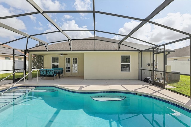 view of swimming pool with a patio, a lanai, and ceiling fan