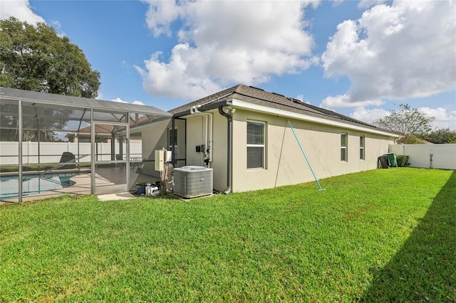 view of side of home with glass enclosure, a patio, a fenced in pool, central air condition unit, and a lawn