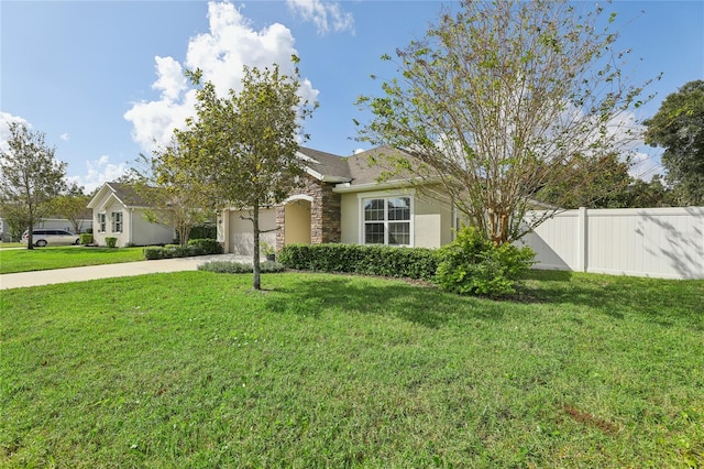 obstructed view of property with a garage and a front lawn