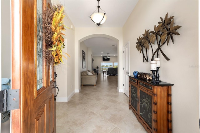 corridor featuring light tile patterned floors