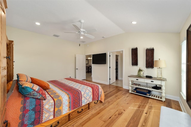 bedroom featuring light hardwood / wood-style floors, lofted ceiling, and ceiling fan