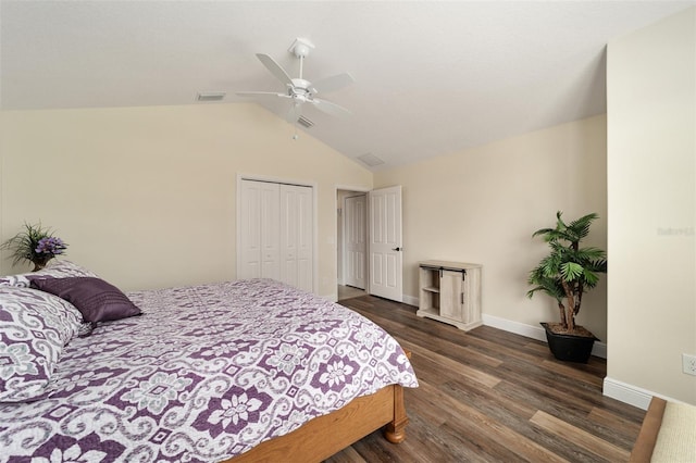 bedroom featuring a closet, dark wood-type flooring, lofted ceiling, and ceiling fan